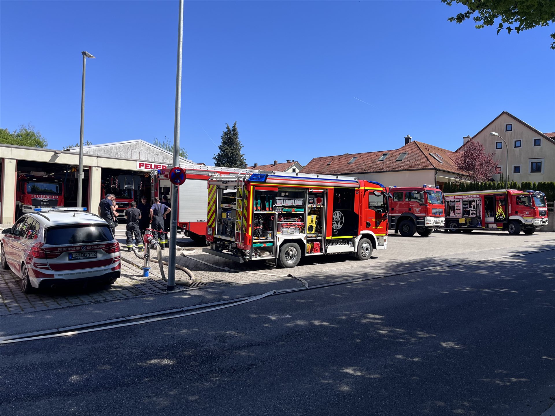 Einsatzfahrzeuge und Polizeiauto vor dem Gerätehaus der Feuerwehr Vilsbiburg während der Ausbildung